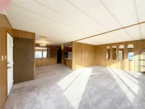 Entry door on the left. The Living Room and Dining Room flow into the Kitchen area.