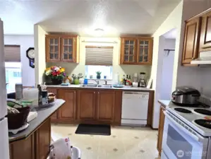 The open kitchen features stylish well-crafted cabinets that add both charm and functionally to the space.