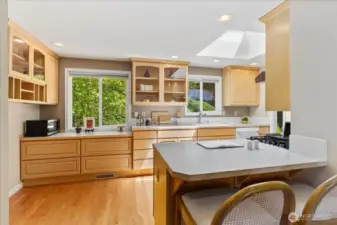 Additional storage and cabinetry added for improved efficiency. Skylight and counter seating. Access from kitchen to 2-car garage.