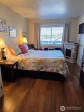 Notice the beatiful real wood floors throughout.  The primary suite has a private full bath and comes with television and electric fireplace.  There is a locking armoire full of high quality linens for the bedroom, bath, and kitchen.