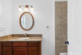 Nice full bath with tiled floors and tile surround in the tub/shower