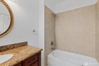 Nice full bath with tiled floors and tile surround in the tub/shower