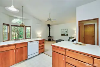 Off of the kitchen is a family room with a wood fireplace. Door on the right leads to the laundry room and garage.
