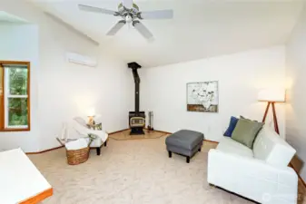 Vaulted ceiling area with a mini split for heating and air conditioning.
