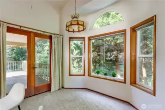 Kitchen area for dining with double doors leading to the deck.
