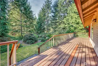 Sunny deck leading out to pathways. The garden is low maintenance and well maintained.