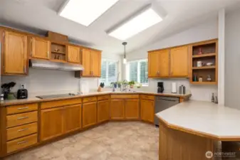 Spacious kitchen has been updated with new flooring, light fixtures and instant hot water