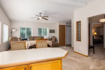 Looking into dining/living room with separate office space to the right