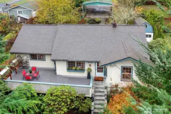 Perched on a hill, this charming home is surrounded by mature landscaping.