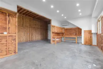 Shop has workbenches, lighting, mini-split heating and cooling