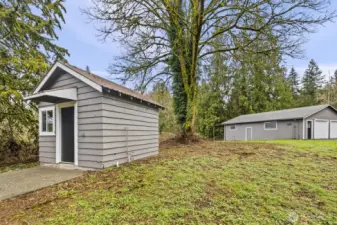 She-shed on the left; detached garage & shop to the right.