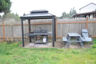 In the back yard, the BBQ has it's own gazebo covering to keep you out of the rain while grilling,.