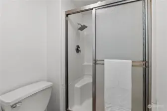 Water closet with toilet and shower can be closed off with pocket door.