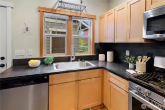 The kitchen includes a gas range, dishwasher, microwave oven and refrigerator.