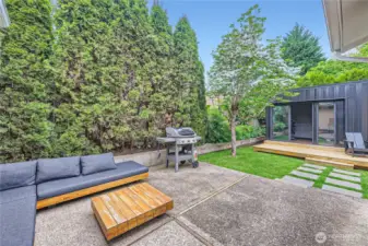 Fully fenced level backyard includes a dettached office.