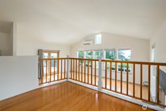 This is an interesting space. It's a slightly raised loft looking over the living room. Perhaps a library, office or hobby area?
