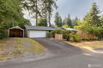 Front of the home, featuring garage and carport.