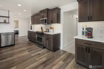 Large kitchen pantry is first door in hallway. Auto-lit. Hallway leads to 3 bedrooms and bath.