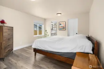 Primary Suite with a full bath, WIC, and French doors to the deck.