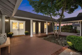 A covered breezeway leads to the pristine and secure two-car garage.