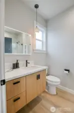 Primary en-suite with modern cabinets and black fixtures