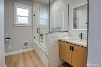 Primary bath with gorgeous floor to ceiling custom tilework
