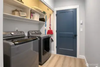 Utility room with built-in shelving. Washer and dryer stay!