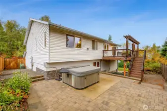 Paver patio with a private hot tub area and easy access to the deck above. Ideal for relaxing evenings or hosting friends outdoors.