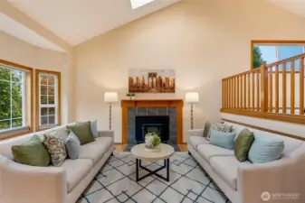 The main living area features a cozy wood stove framed by tile and a wood mantel, anchored by tall windows that fill the space with daylight. Perfect for relaxing or gathering with everyone.