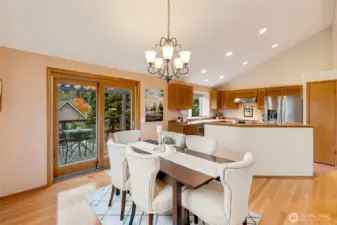 The dining area flows easily into the kitchen, creating an ideal setup for hosting. Vaulted ceilings, recessed lighting, and warm finishes enhance the welcoming feel.