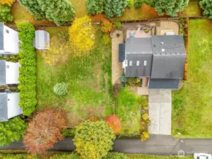 A true sense of space! The large fenced yard with huge side yard, entertainment deck, and mature trees offering a natural backdrop.