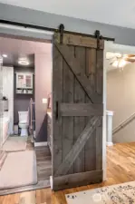 Barn door in main bedroom leads to over the top main bathroom!
