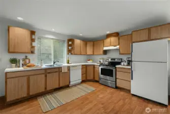 Efficient kitchen with ample cabinetry, counter space, and direct connection to the main living areas.