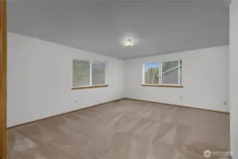 Comfortable primary bedroom featuring generous space, natural light, and convenient access to the home’s bathroom.