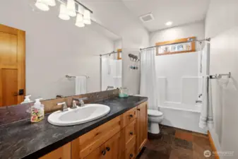 Main bath, gorgeous cabinets and slate flooring