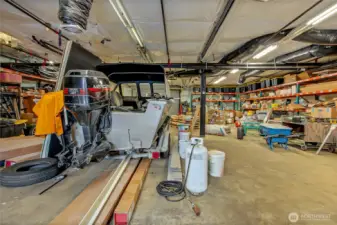 Large heated shop offf of fenced area. Shelving to remain.