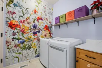 Laundry room with counter space and there is an entrance to the crawl space for easy access just before you head out to the garage.