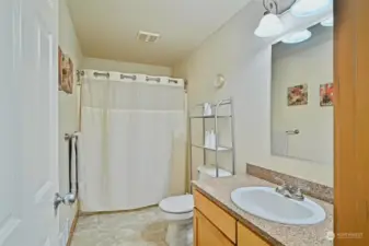 Full main bathroom on the second floor with shower/tub combo and granite countertops and backsplash.