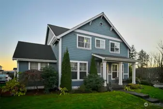 Front of home with a beautiful sunset in the back.