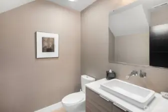 The main floor powder room continues the clean lines and fine finishes