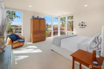 The palatial northwest corner primary suite enjoys more high ceilings and even more sweeping city & mountain views