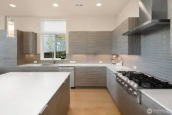 It's easy to make cuisine your fluent love language with custom cabinets, a sea of white quartz and high-end, stainless appliances including an Electrolux 6-burner gas cooktop
