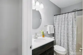 Remodeled four piece bathroom with chrome fixtures throughout.