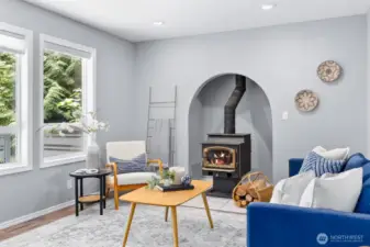 The alcove housing the stove is a cozy architectural feature, adding charm to the space while staying warm year-round.