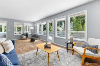 Strategically positioned Western and Southern windows provide ample natural light in this open concept living room.