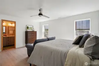 Primary suite has vinyl flooring and huge walk in closet and a bathroom with double sinks and tons of storage