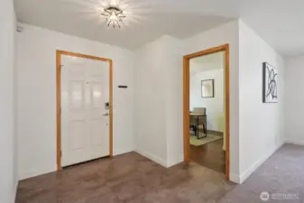 The entry with new vinyl floors, looking into the 3rd bedroom