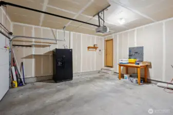 2 car garage, fridge stays! Fast EV charger installed and will stay as well