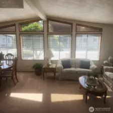 Living room with vaulted ceilings and full of windows.