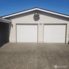Standing tall, two car garage with openers. Garage and home have newer roof and gutters.